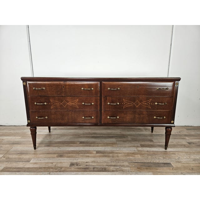 An elegant vintage oak chest of drawers dating back to the 1960s, characterized by refined decorative taste and...