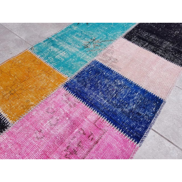 This is a vintage Turkish Oushak rug from the Mid 20th Century. The piece was hand-knotted.