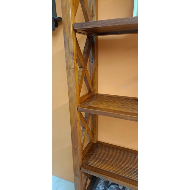 Elegant freestanding bookcase in solid cherry wood. It features a rustic style with cross-shaped sides. Open structure...