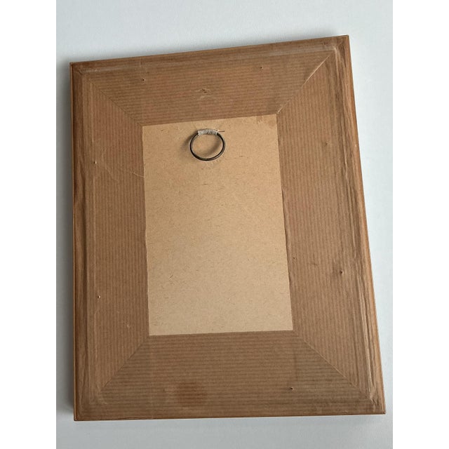 A quietly expressive figurative drawing depicting a woman engaged in washing clothes at a wooden basin, rendered with...