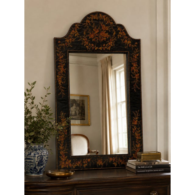 Elegant vintage Chinoiserie-style mirror featuring a black lacquered frame with hand-painted floral and botanical...