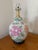 Vintage Chinoiserie ginger jar table lamp with pink and peach peonies on a white ground. Round black wooden base and...