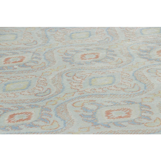 Made with hand-knotted silk, this 9x12 rug is inspired from traditional Ikats rug and textile weaving traditions, and is...