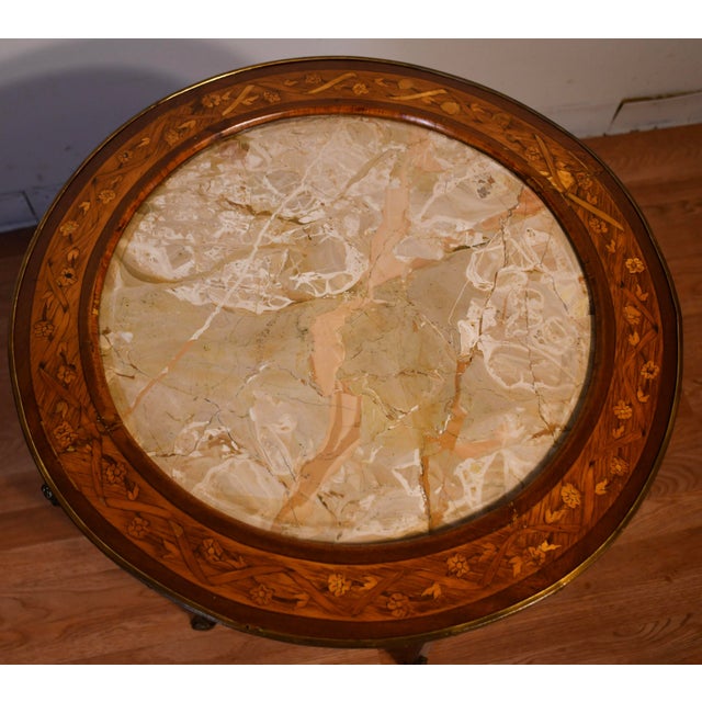 We are pleased to offer this beautiful Antique French side table, from the 1900s. This table is made of Walnut & Satinwood...