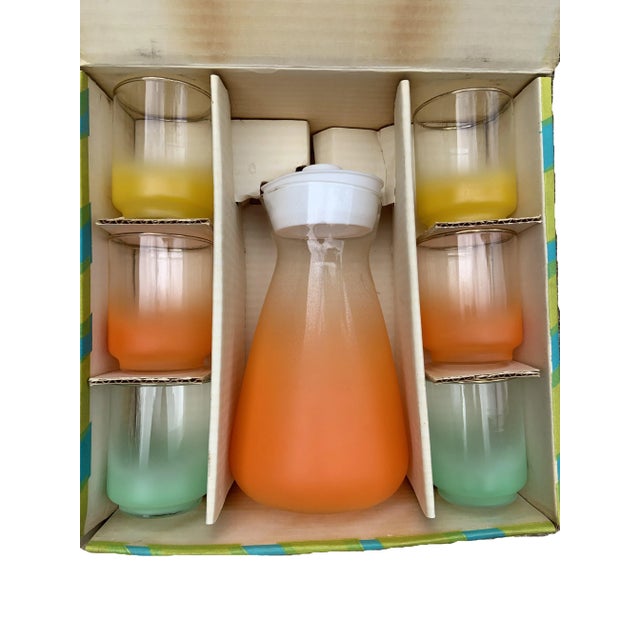 The Vintage 60s Satin by Libby Multicolor 7 Piece Glass Juice Set is a true treasure from the past, capturing the essence...