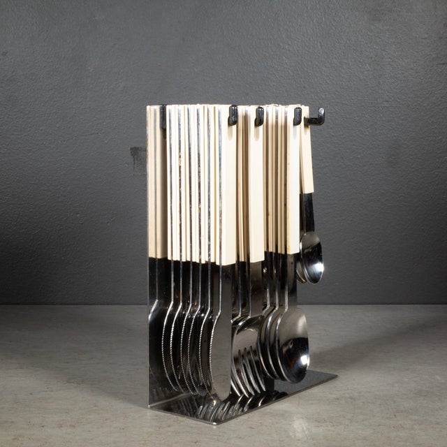 ABOUT An original mid-century cutlery set and stand by Abert, Italy. Stainless steel with ABS plastic handles and...