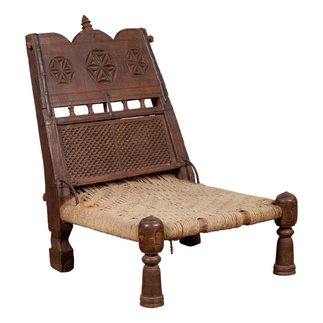 Antique Indian Rustic Low Seat Wooden Chair with Carved Rosettes and Twine Seat For Sale