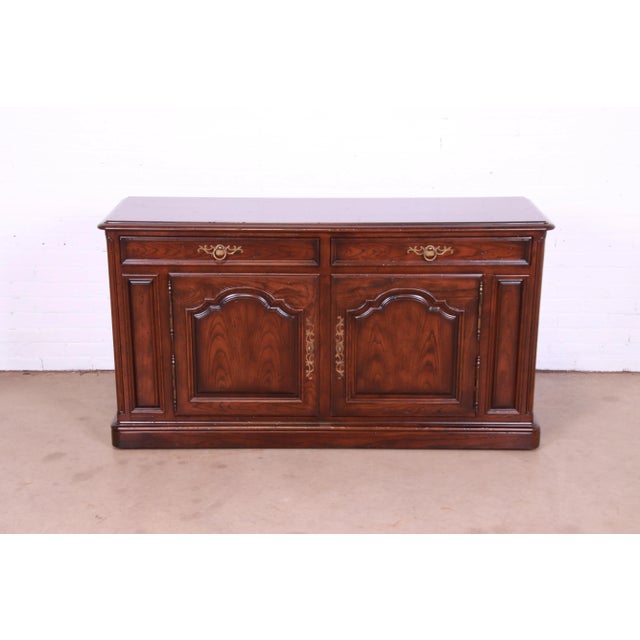 A gorgeous French Country Louis XV style rolling bar cabinet, sideboard, or credenza By Henredon USA, Circa 1970s Carved...