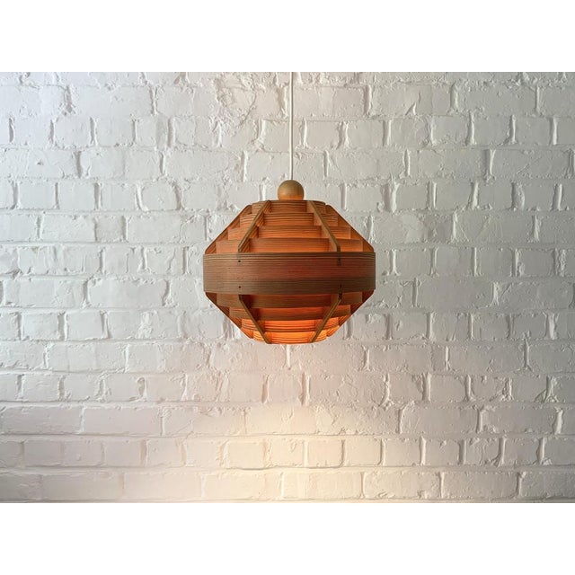 Pine veneer pendant lamp model T-510 by Hans-Agne Jakobsson. Manufactured by AB Ellysett in Sweden. The lamp is composed...