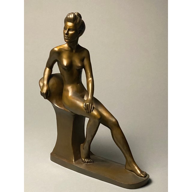An elegant nude sculpture by Irish artist Gabrielle, depicting a young female athlete in a moment of relaxation. Cast in...