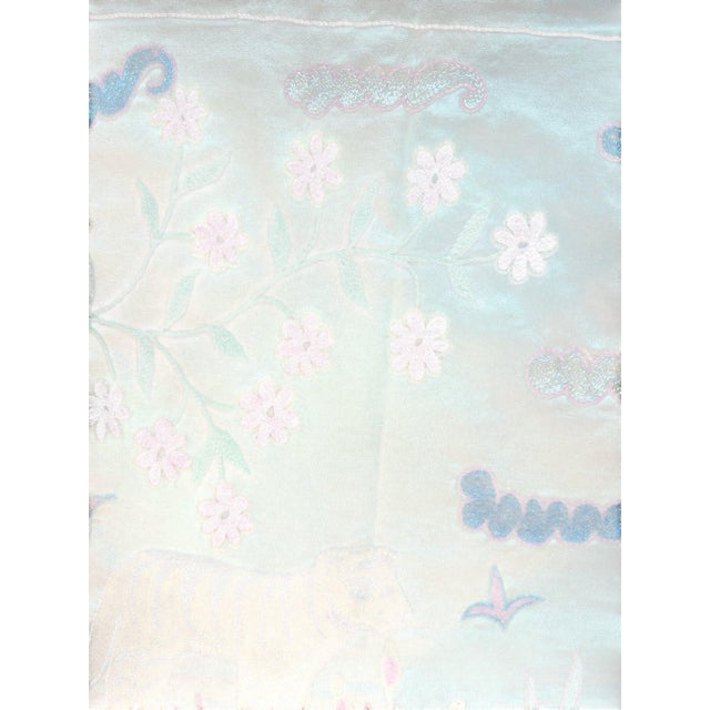 Hand-embroidered Suzani panel from Uzbekistan, worked in fine floss on a cream cotton ground. Three tigers move across the...