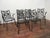 A very fine set of Woodard wrought iron patio chairs. Circa 1960. The backs of the chairs are the design focal point. The...