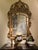 This antique 19th century french giltwood overmantel mirror, carved as a “marriage mirror” with foxed glass, was...