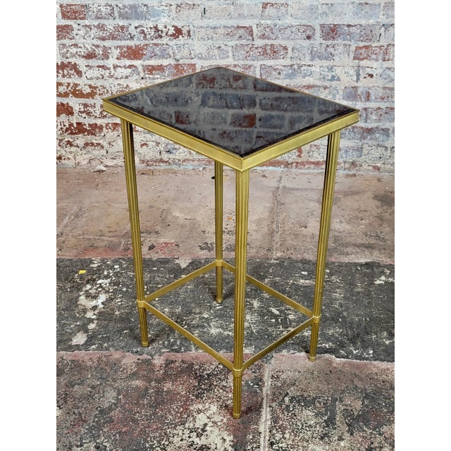 French Directoire Brass Side Table with Black Granite top Dimensions: 28" H x 17" W x14" D" A beautiful piece that will...