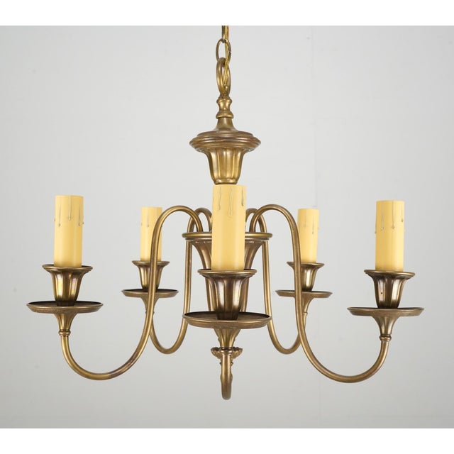 Colonial style brass chandelier with five swooping arms and a patina finish. The chain is made of steel. This light...