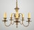 Colonial style brass chandelier with five swooping arms and a patina finish. The chain is made of steel. This light...