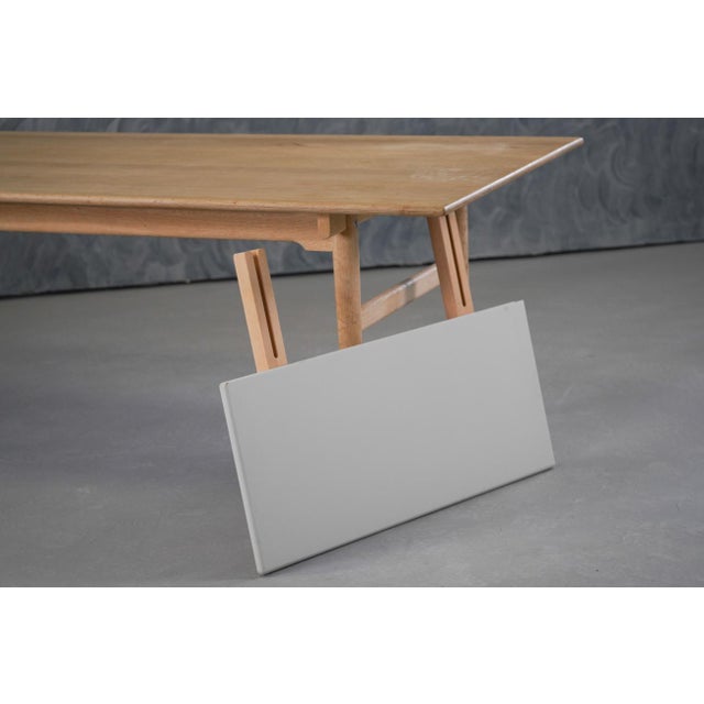 Originally designed in 1962 by legendary creator Hans J. Wegner, the 'CH327' table appears to float above the frame...