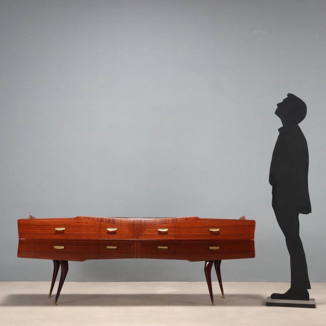 Vintage Italian-made eight-drawer chest of drawers, back-treated glass top, exotic wood veneer, stained beech wood legs,...