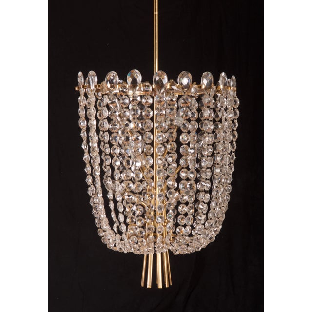 This brass construction with cut crystal elements is fitted with nine E14 sockets up to 60 watts each. It was made in...