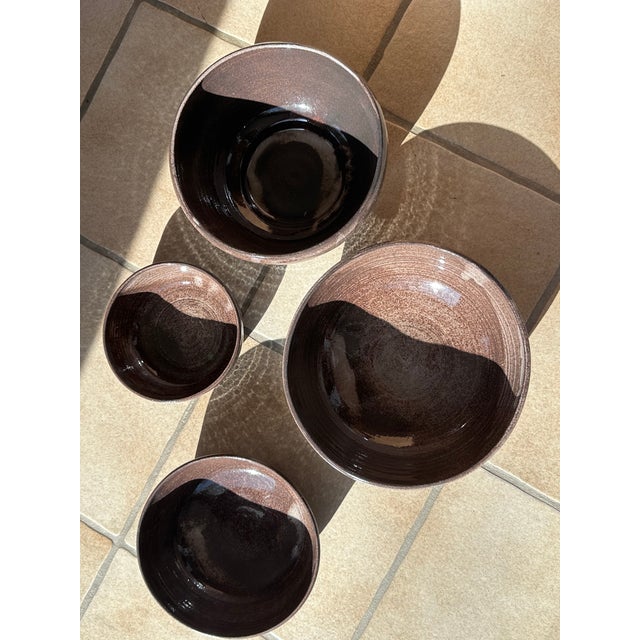 This set of ceramic bowls from the Serocka workshop showcases the characteristic warm brown glaze with its fine speckles...