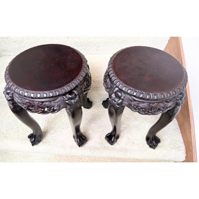 This is a pair of antique (circa 1920’s) Chinese hand carved Canton Rosewood side tables / display stands, featuring...
