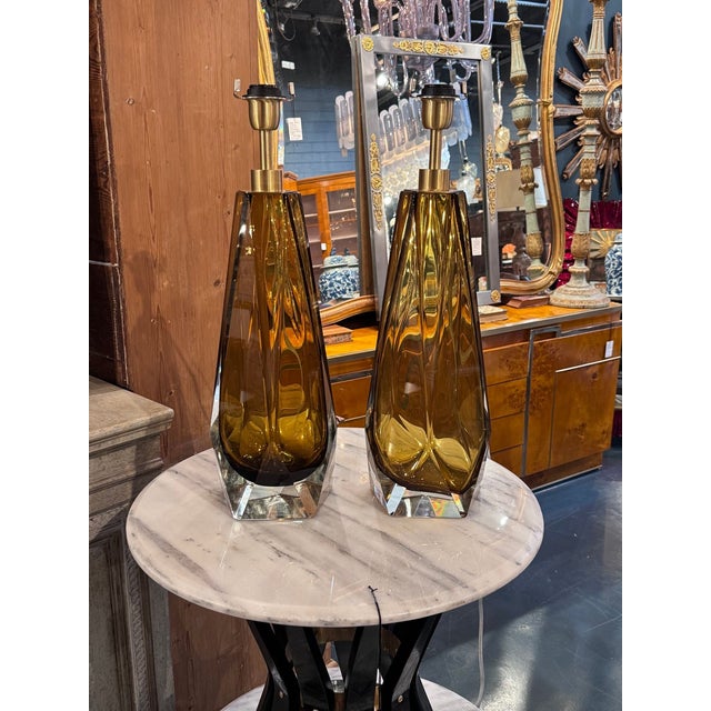 The product is a lovely set of Murano Amber Glass Lamps,. These lamps add a touch of elegance and warmth to any room with...