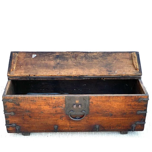 DETAILS An antique Korean money coffer (Ton-Kwe) or trunk of rectangular form, with hinged lid and iron mounts. PLACE OF...