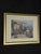 Elegant framed coastal landscape artwork featuring a seaside villa, garden patio, ocean view, mountains, and...