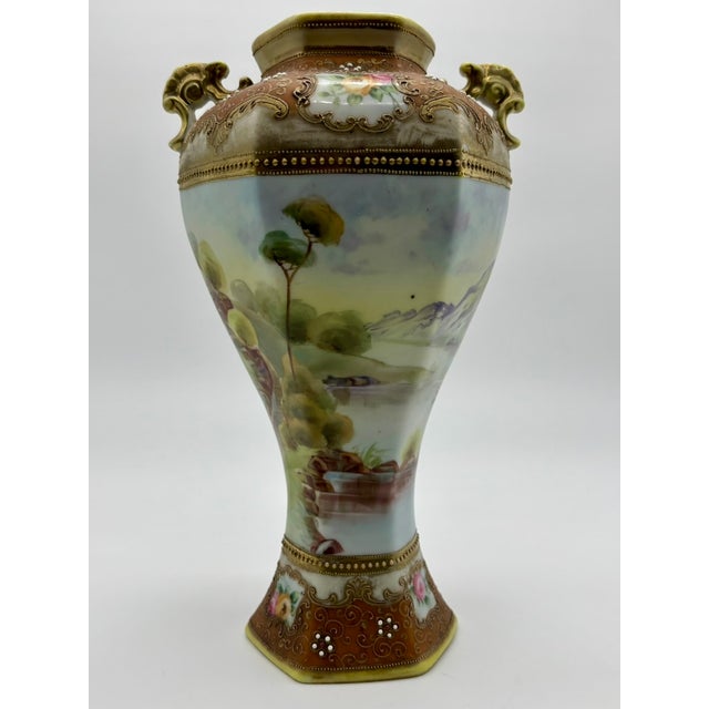 Beautiful antique Nippon/Japan two-handled porcelain vase features a hand-painted landscape scene done in exquisite detail...
