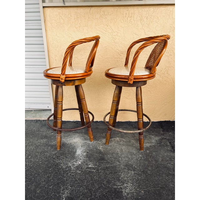 Mid-Century Modern bar stools. Pair of Tiki bar upholstered bamboo and wood. These bentwood stools have swivel seats and...