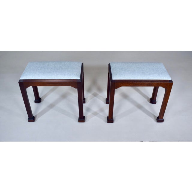 A pair of Chippendale style bench footstools by Madison Square, of Hanover, Pennsylvania, USA. Constructed of solid...