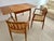 Classic Danish mid-century modern teak dining table with rounded corners and two (2) end-leaf folding extensions; two (2)...