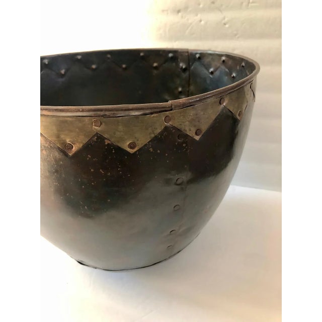This fabulous Large Hand Forged Dark Copper Planter with Rivets has a geometric brass trim across on the upper edge of the...