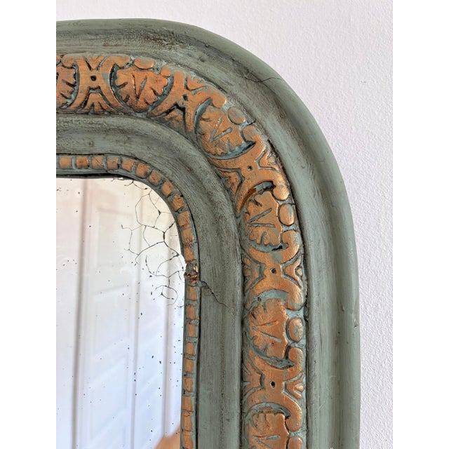 An elegant antique French Louis Philippe mirror dating from the late 19th century. This mirror features original mercury...