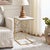Elevate your living space with the Keston marble c-table. Featuring a white marble top and sleek gold legs, this piece...