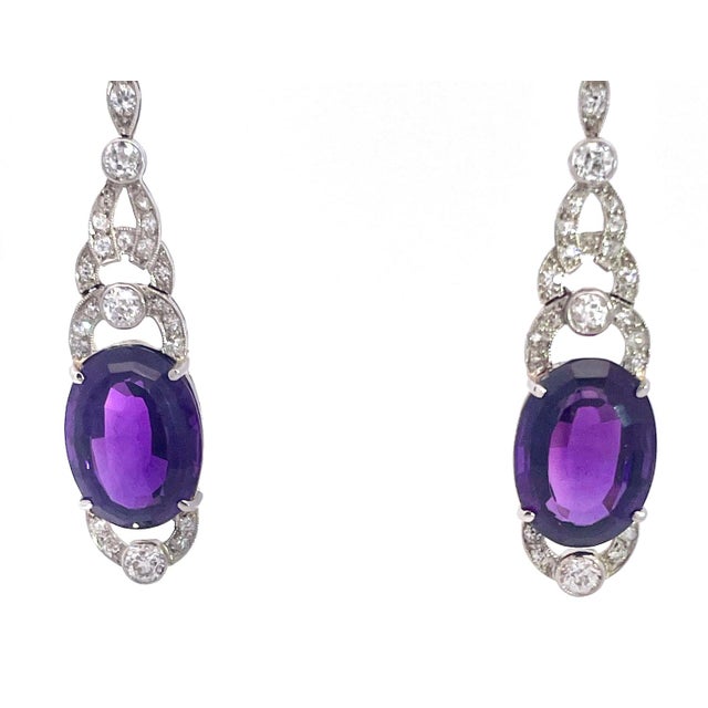 These exquisite drop earrings pair Edwardian romance with Art Deco elegance. Each hangs from a slender navette-shaped top...
