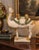 A substantial vintage Chinese ceramic camel sculpture inspired by Tang Dynasty funerary figures. The camel is modeled with...