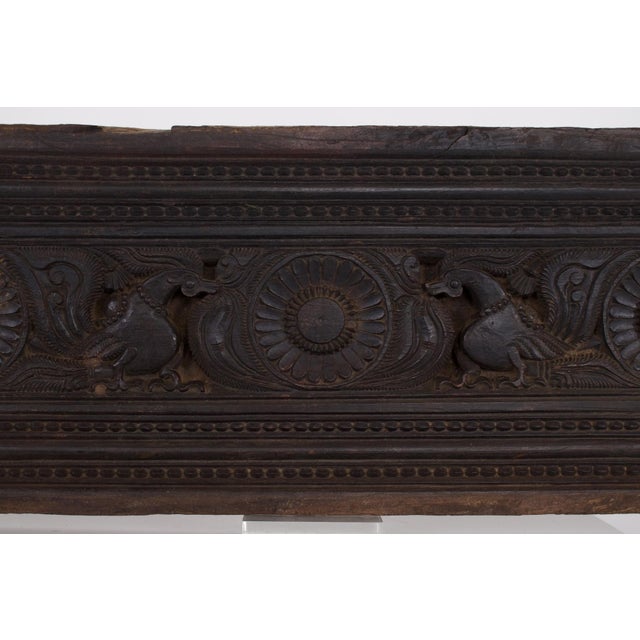Originating from the Chettinad region of Tamil Nadu, this antique carved wooden panel exemplifies the refined decoration...