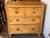 Two short drawers over two long ones, each with turned wood knobs, on a plain 19th century English case with turned feet....