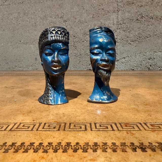 For your consideration, a pair of blue and gold-toned bust figurines depict a man and a woman in a stylized, artistic...