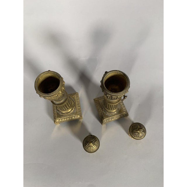 A pair of Louis XVI period gilt bronze cassolette candlesticks. The candlesticks rest on four ball-shaped feet. The base...