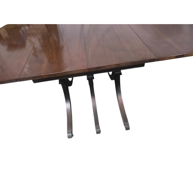 Vintage mid-20th-century Duncan Phyfe–style dining table with a warm mahogany-toned finish and versatile drop-leaf...