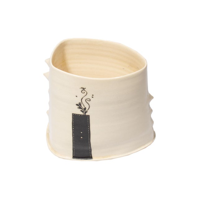 A studio pottery vase by the Japanese ceramic artist Reiko Miyagi. The vase features a whimsical design of a tree trunk...