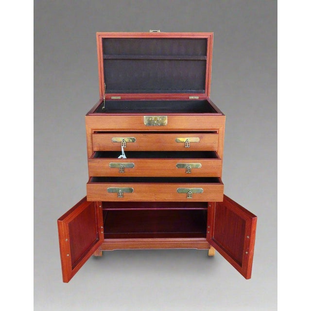 Gorgeous rosewood flatware/silverware chest organizer with flip top and three felt lined drawers. Gold toned Asian...