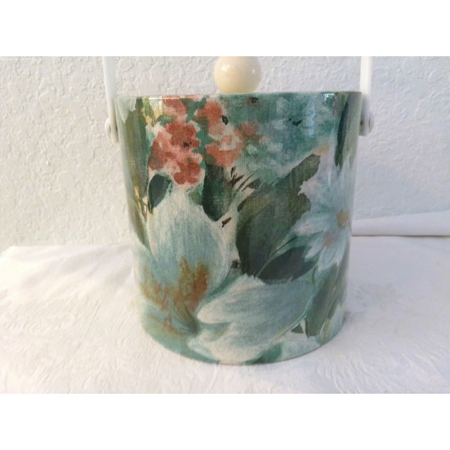 Lovely sea foam green and rose floral vinyl wrapped ice bucket featuring a white hard plastic levered handle and clear...