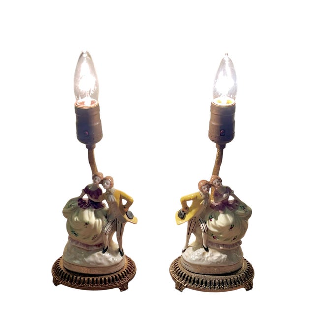Delightfully romantic, this charming pair of antique French porcelain boudoir lamps features beautifully modeled courting...