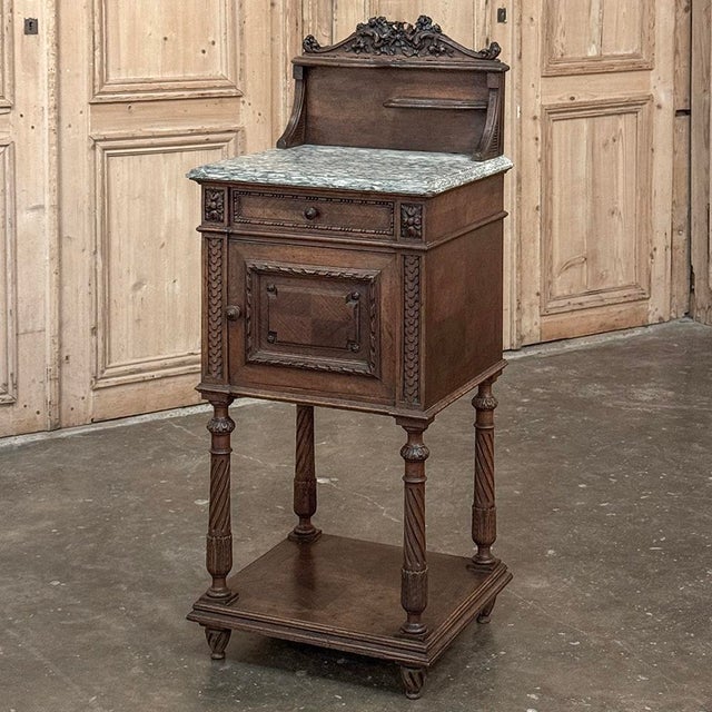 19th Century French Louis XVI Walnut Marble Top Nightstand is a remarkable example of fine French craftsmanship. Produced...