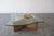 Striking postmodern coffee table featuring a sculptural leather base and a thick freeform glass top. The table has a bold,...