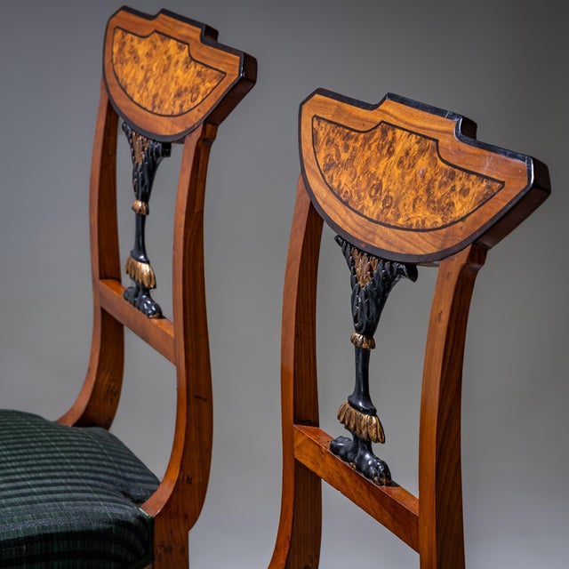 Pair of Neoclassical chairs crafted from cherrywood, featuring square tapered front legs and slightly splayed saber legs...