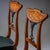 Pair of Neoclassical chairs crafted from cherrywood, featuring square tapered front legs and slightly splayed saber legs...